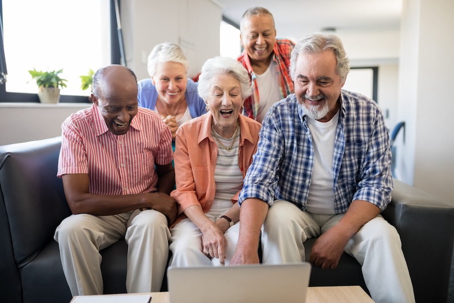 Seniors around computer learning Facebook